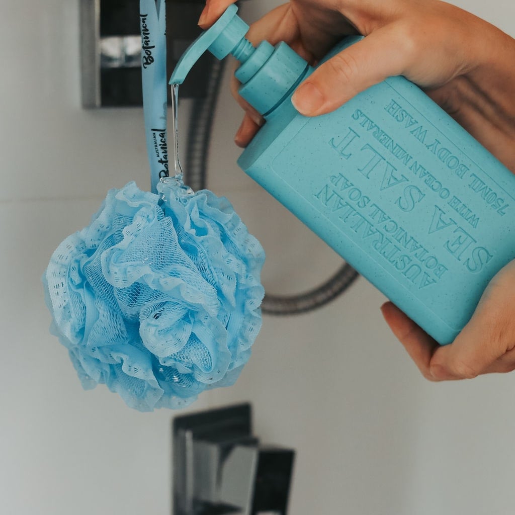 pouring body wash on shower puff