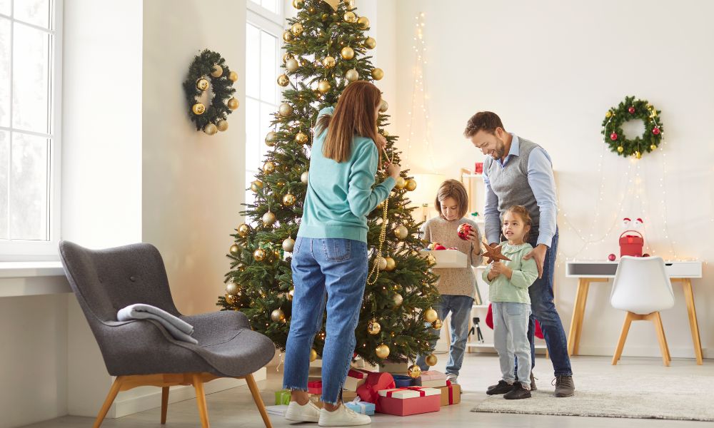 young family decorating Christmas tree