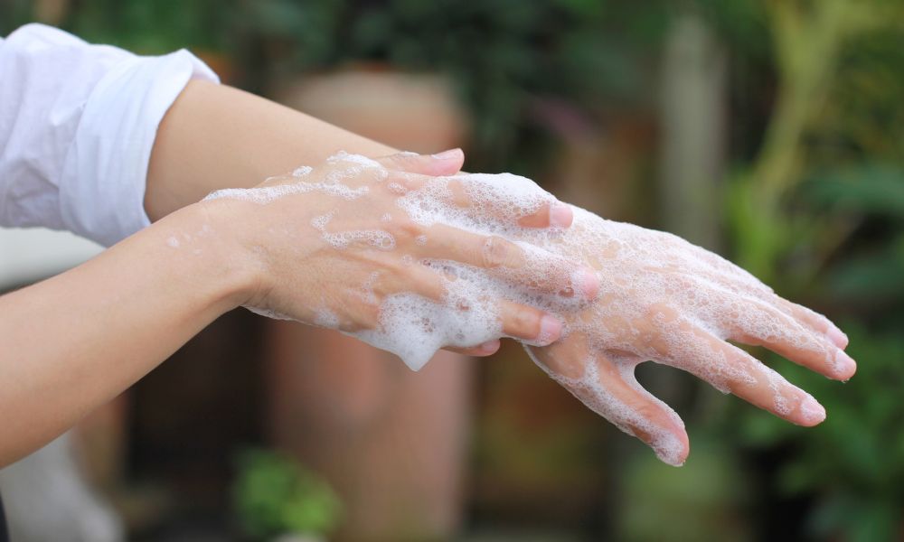 person washing their hands with natural soap