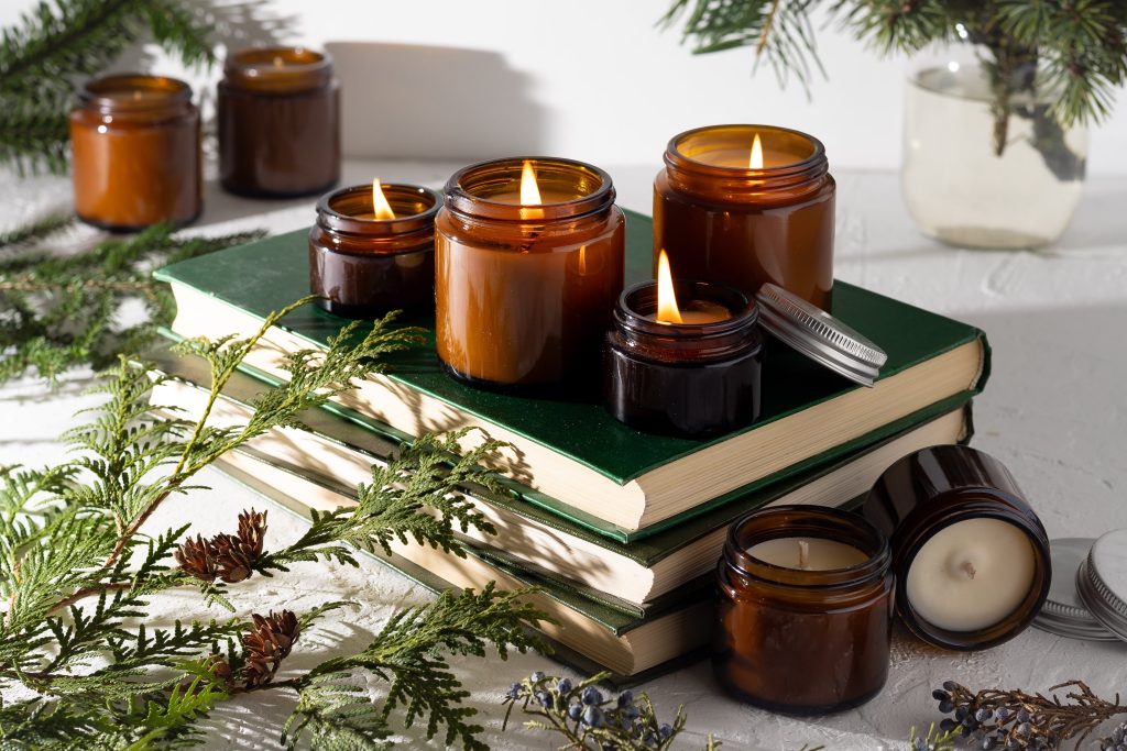 candles on a book with leafs 