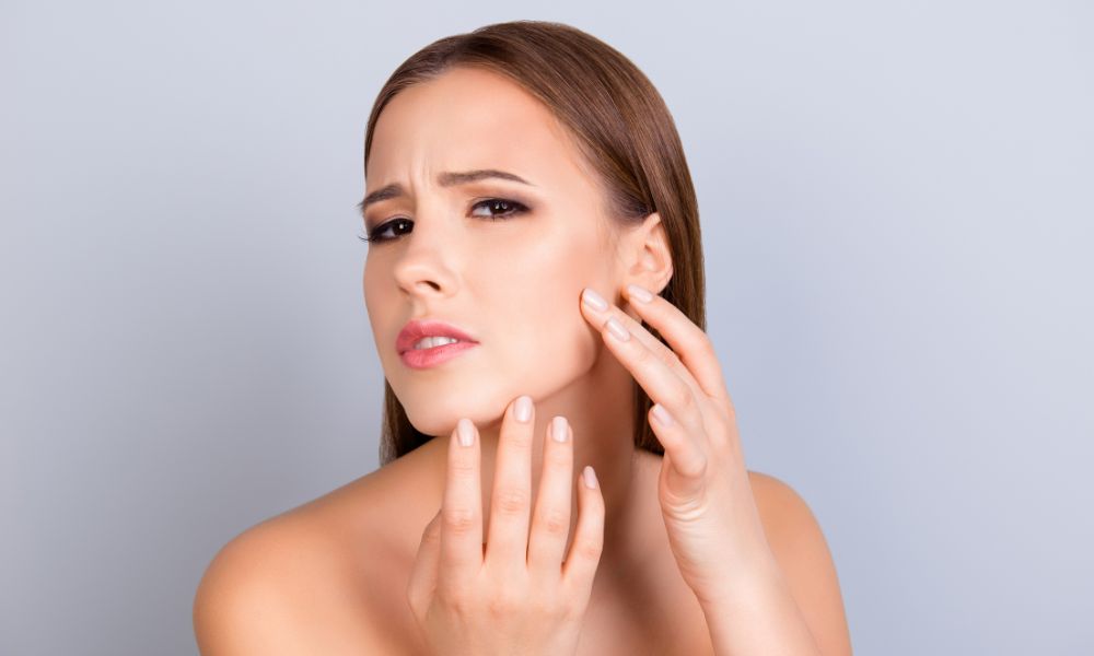 pretty women unhappy with her dry skin